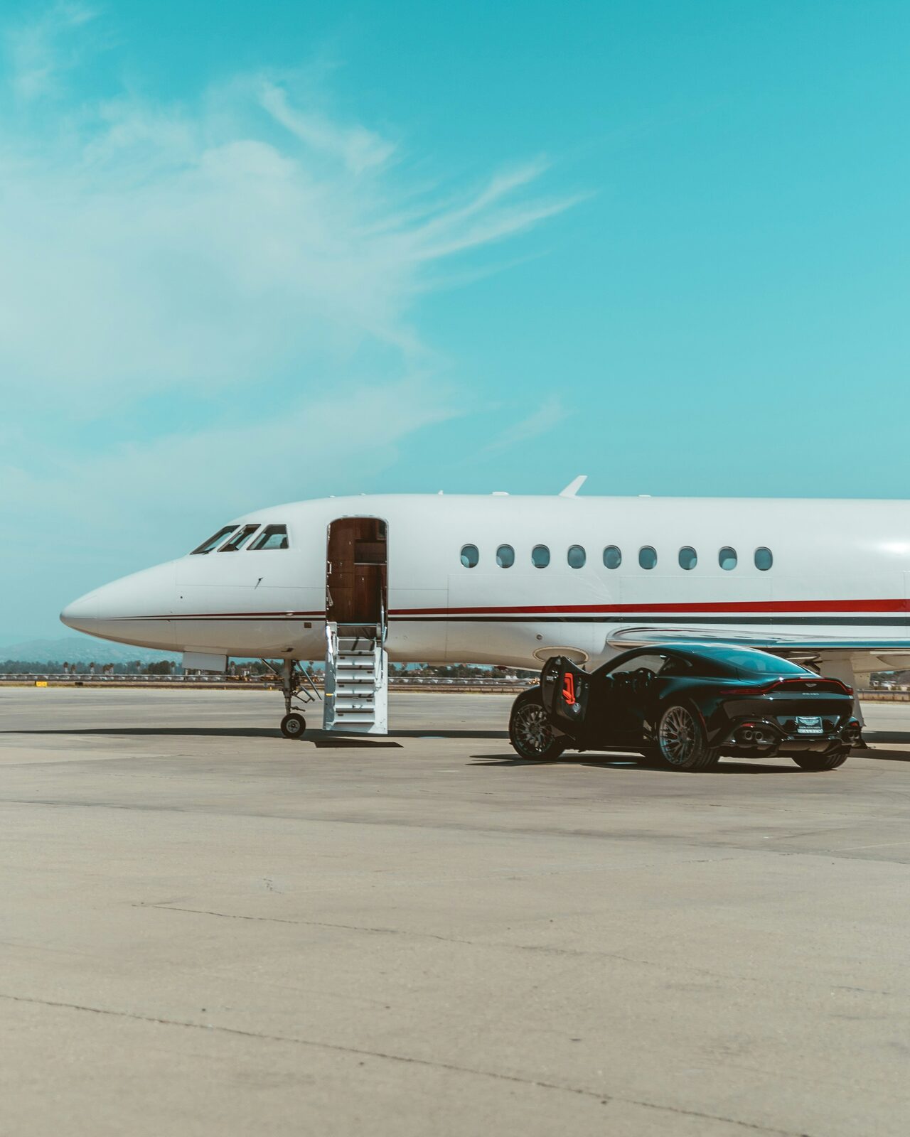 Private jet with car parked on tarmac